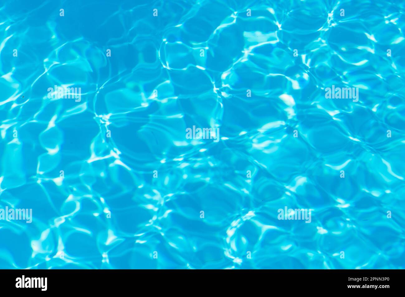 Blue pool water with sun reflections background Stock Photo