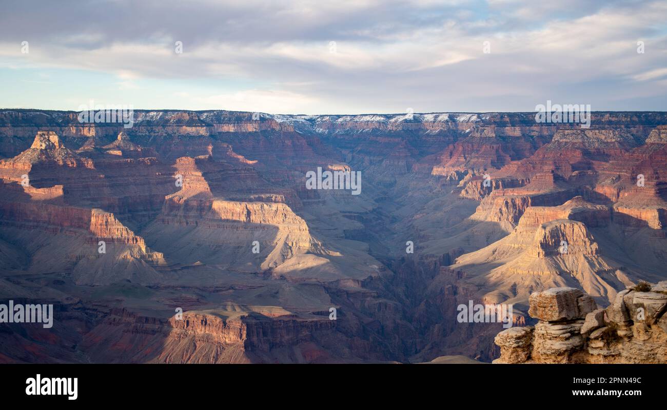Breathtaking views of the majestic Grand Canyon, surrounded by rocky formations and cloud-filled skies. Natures beauty in all its glory. Stock Photo