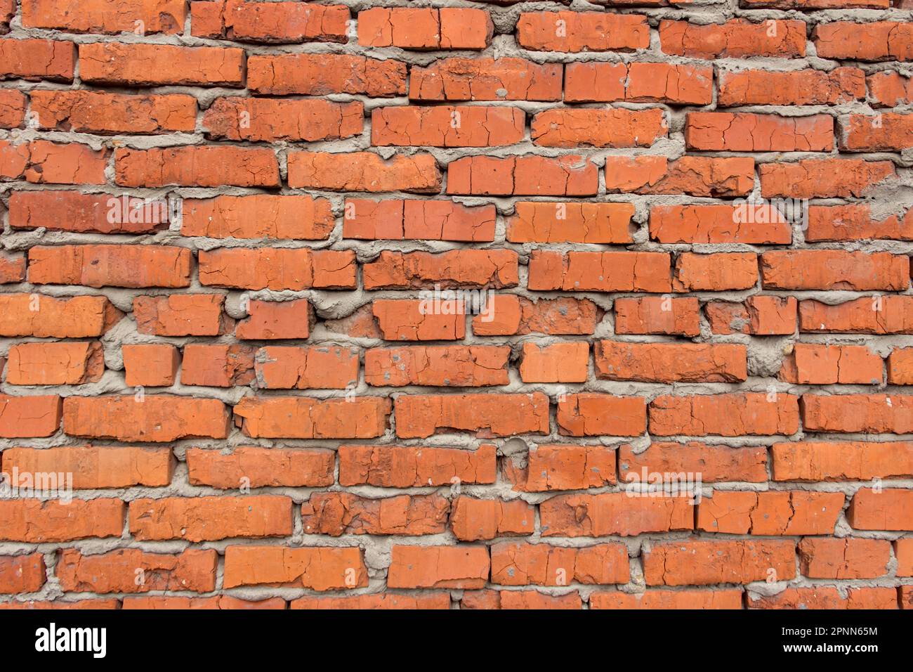 Fragment of a brick wall of an old red brick building. Background for text Stock Photo