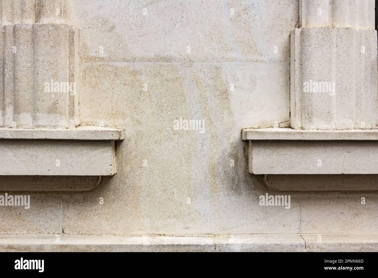 Fragment of a stone wall of an old building. The plaster has undergone natural aging. Background for text Stock Photo