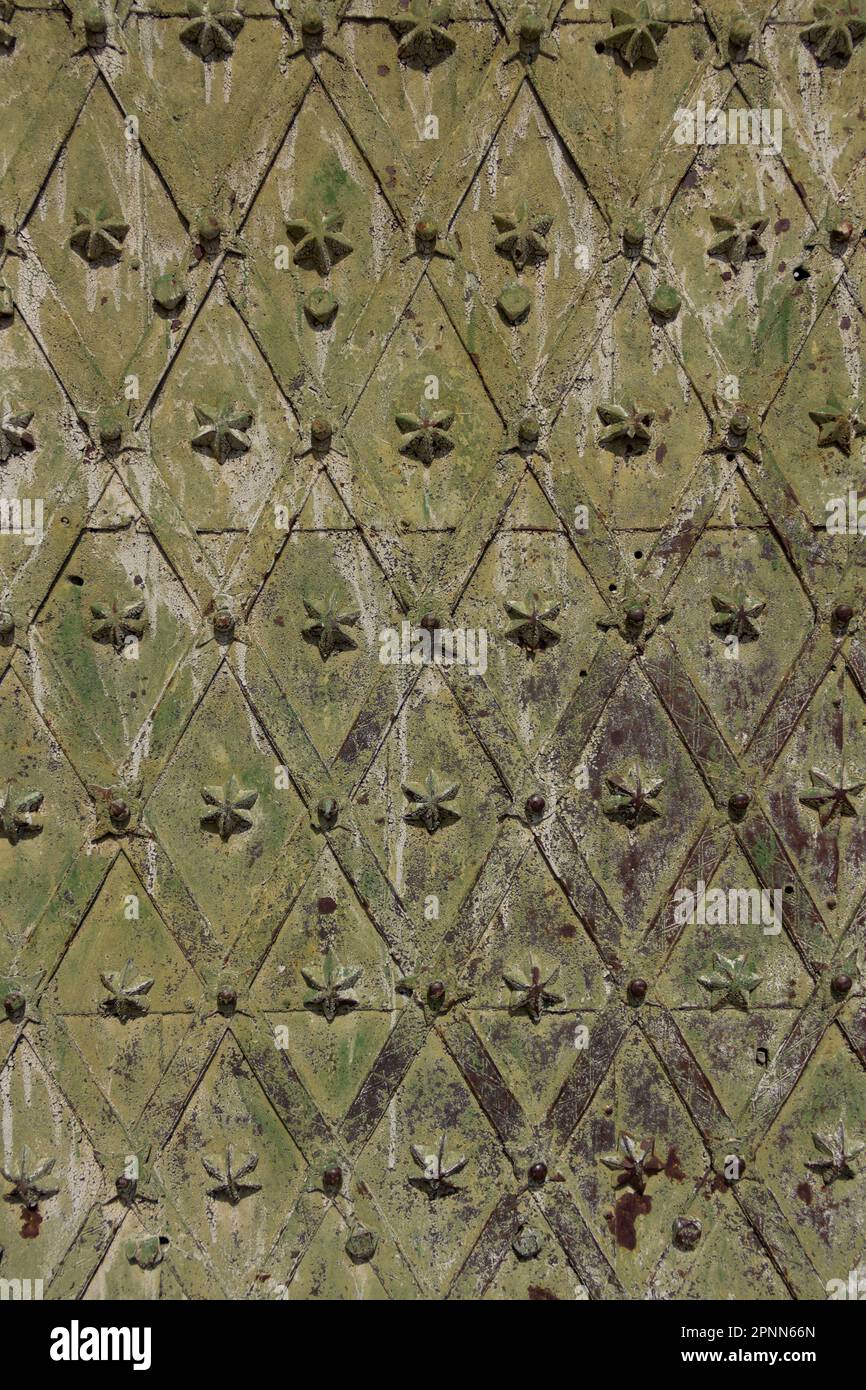 Fragment of a metal door of an old building. The metal has undergone natural aging. Background for text Stock Photo