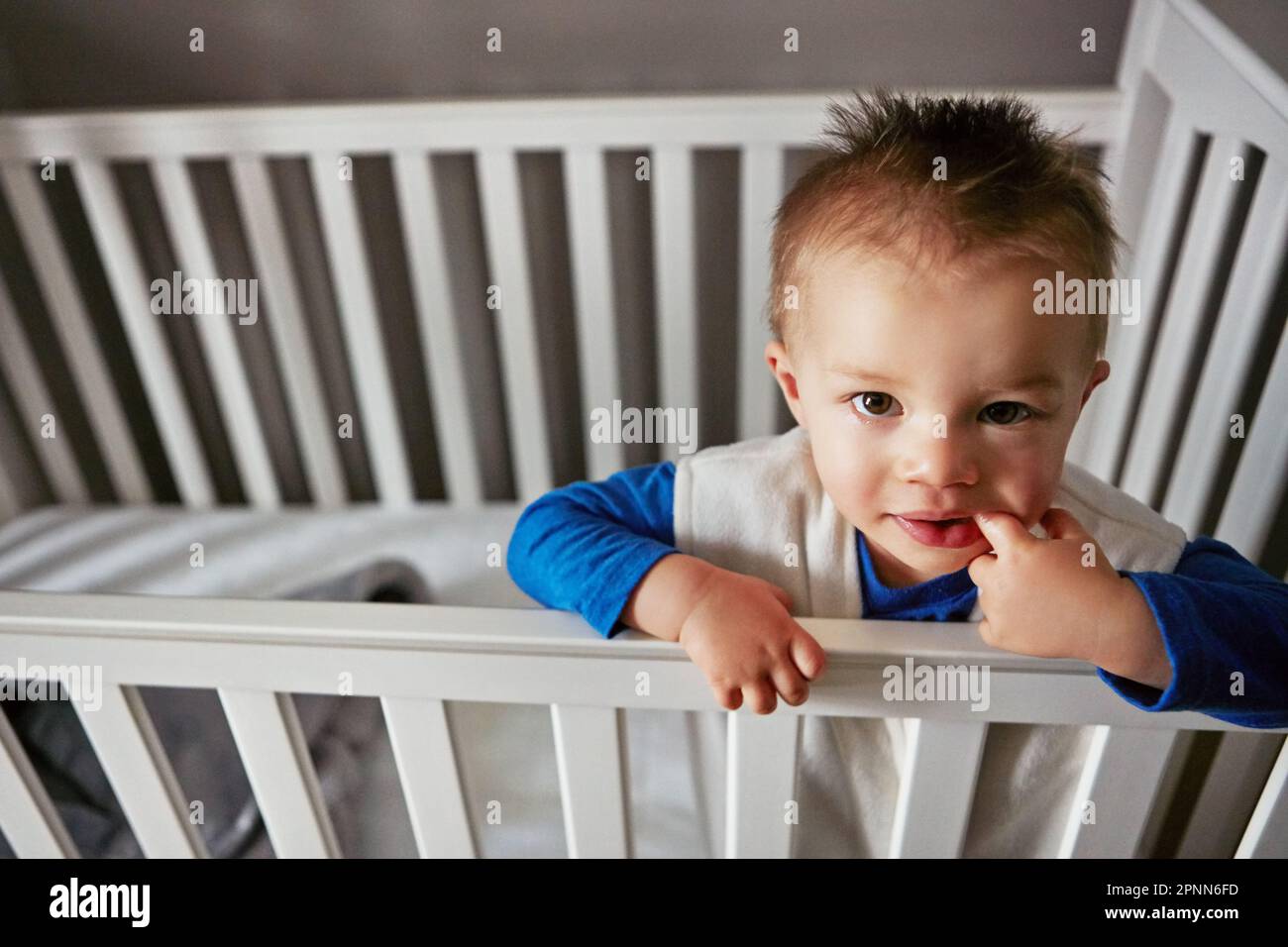 I dont feel like napping, ok. a cute little baby boy standing in his ...
