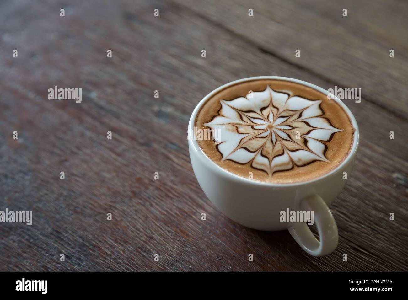 Cup of coffee with latte art on top with wooden table background Stock ...
