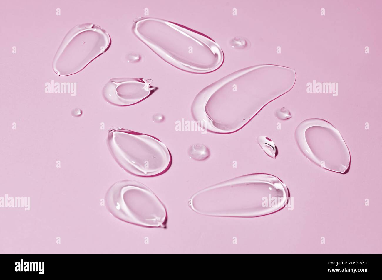 Set of transparent face gel is isolated on pink. A sample of cosmetics ...
