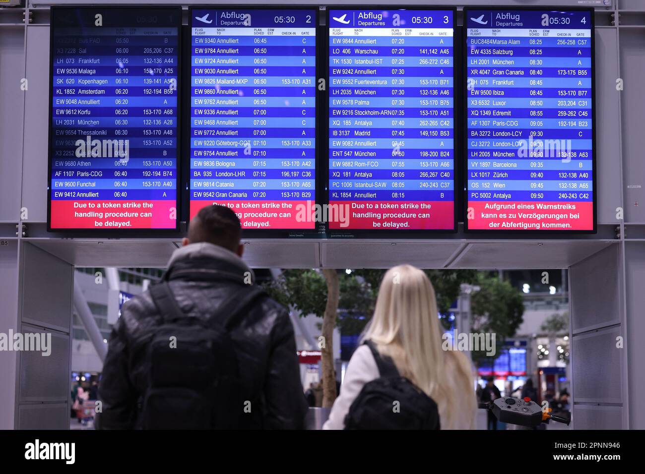Duesseldorf, Germany. 20th Apr, 2023. Passengers look at an information