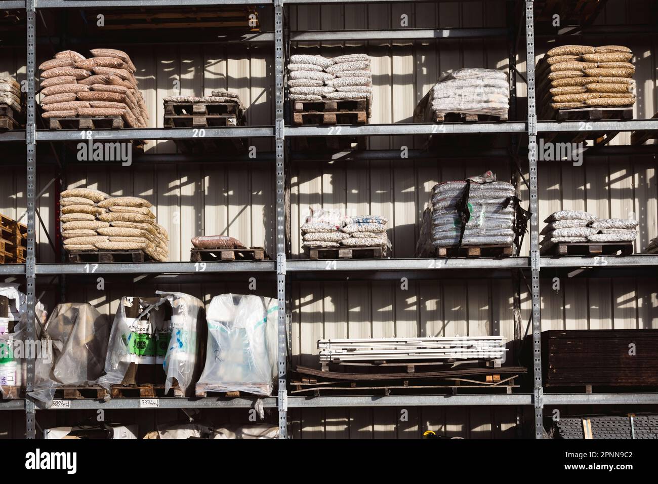 Industrial supplies stored on metallic shelves in an outdoor storage