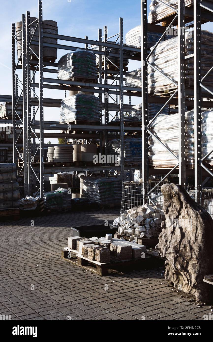 Industrial supplies stored on metallic shelves in an outdoor storage