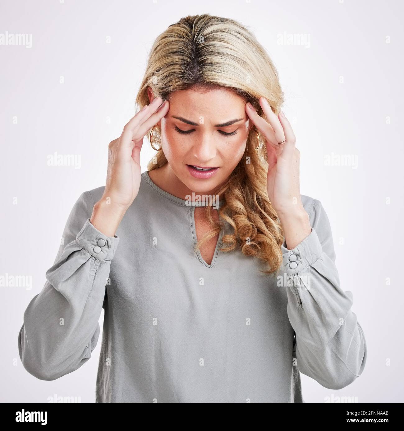 Stress, anxiety and woman in studio with headache, brain fog and pain