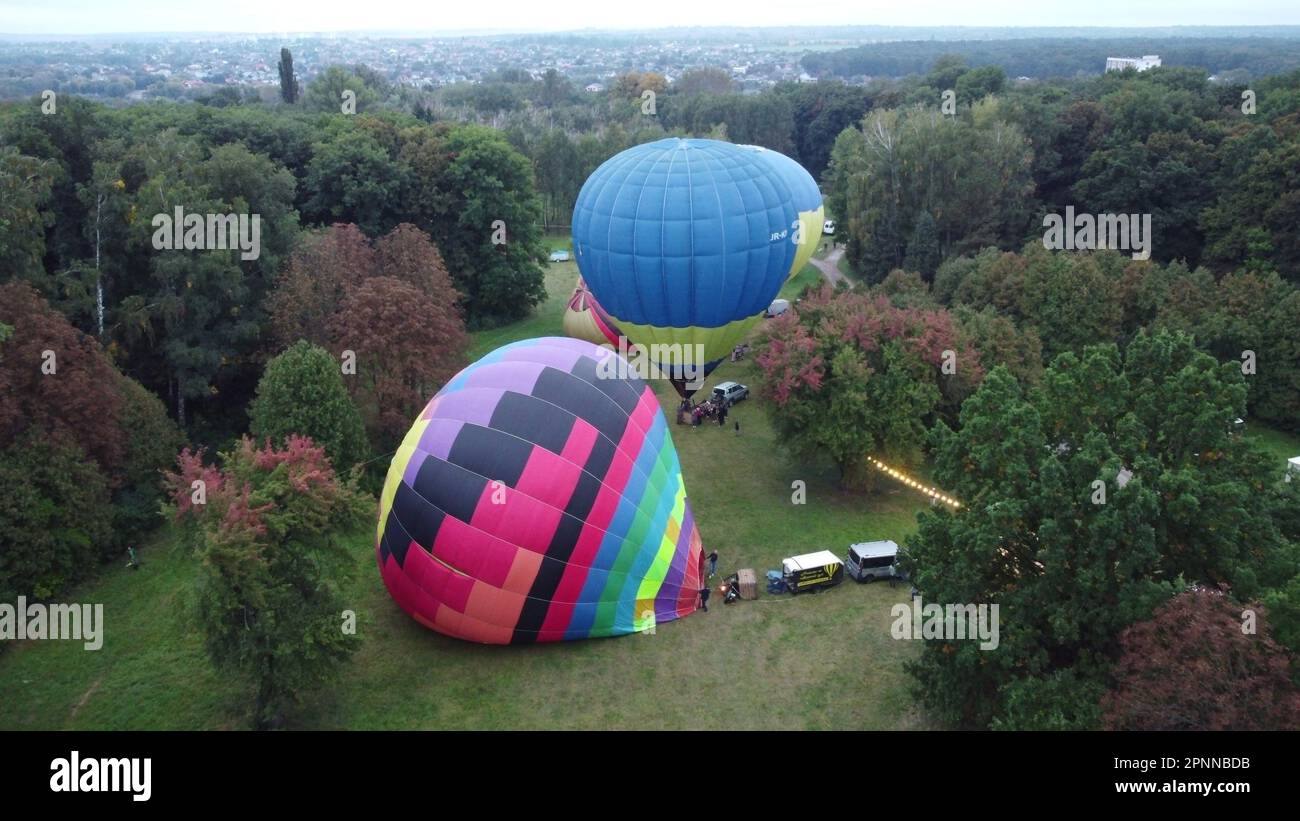 Balloon Festival. Inflating and lifting big balloon aerostat. Several ...