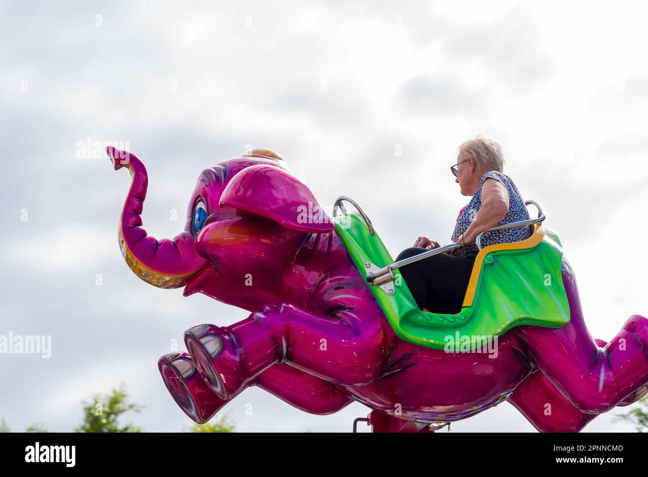 An older woman riding on an elephant ride at the 2023 Royal Easter Show in Sydney, Australia Stock Photo