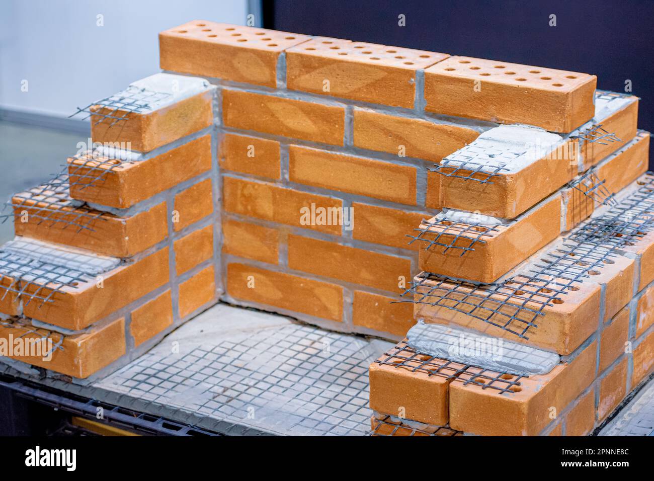 Brickwork using basalt mesh. Construction mesh Stock Photo - Alamy