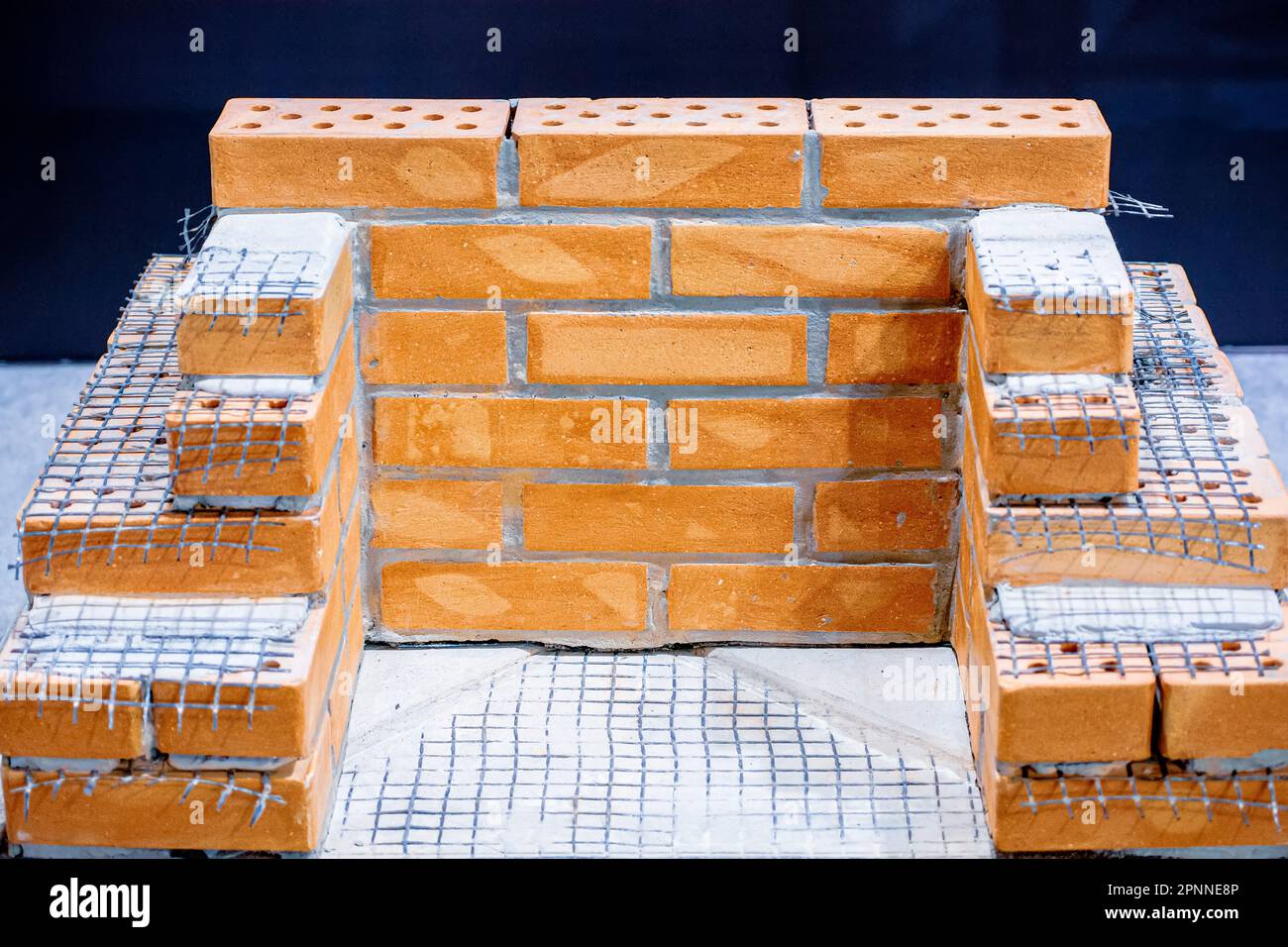 Brickwork using basalt mesh. Construction mesh Stock Photo Alamy