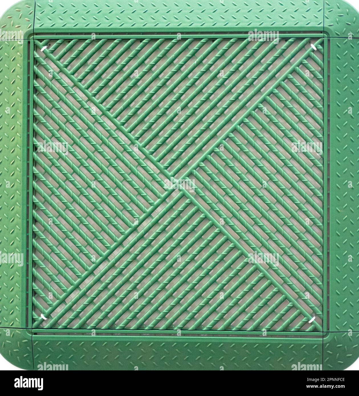 Square green plastic lawn grate. Stock Photo