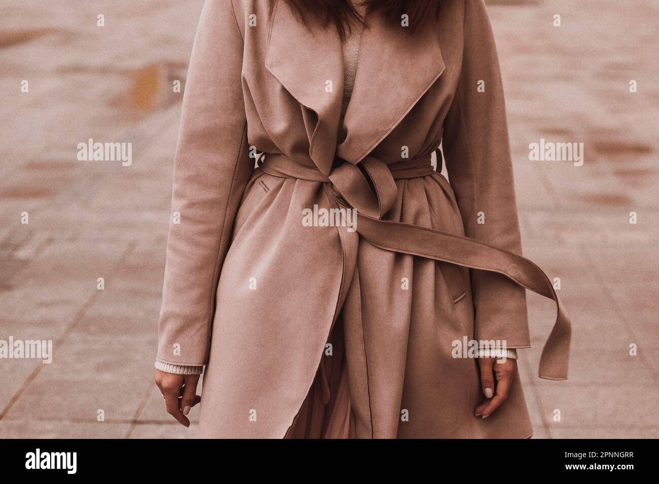 Female figure in the brown long overcoat. Outdoor portrait in daylight. Autumn clothes street style concept Stock Photo