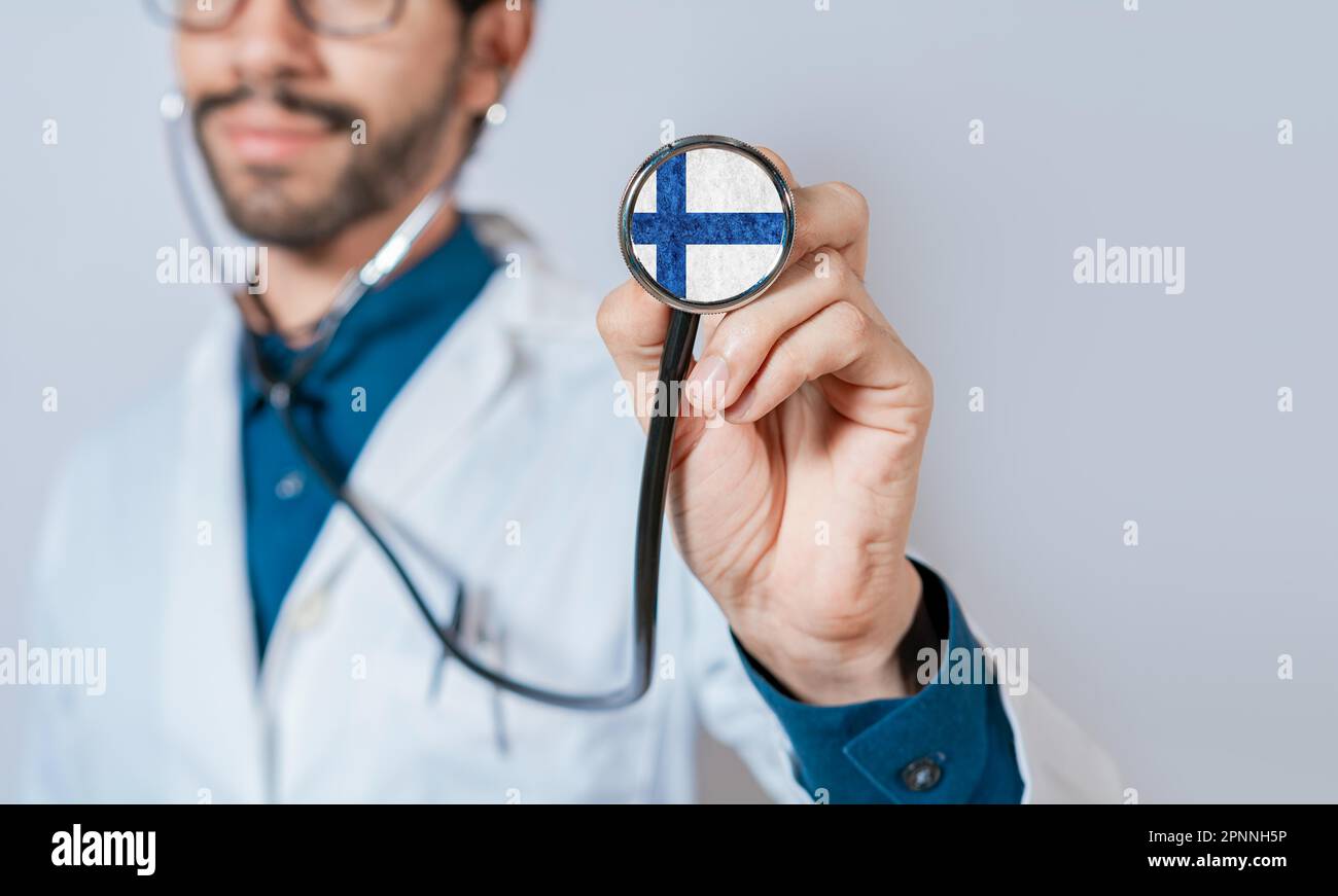 Doctor holding stethoscope with Finland flag. Finland Health and Care