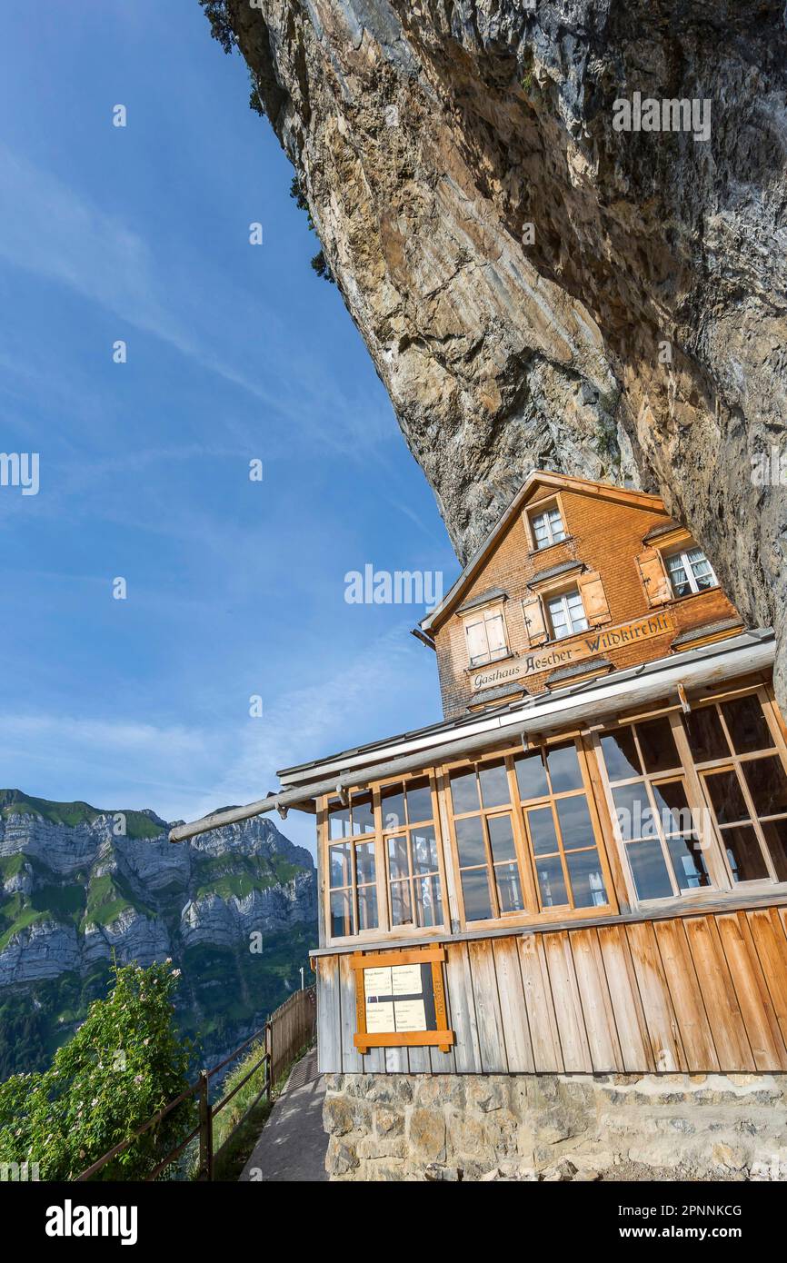 Aescher-Wildkirchli mountain inn, built into the rock below Ebenalp under a steep cliff. Weissbad, Canton Appenzell Innerrhoden, Switzerland Stock Photo