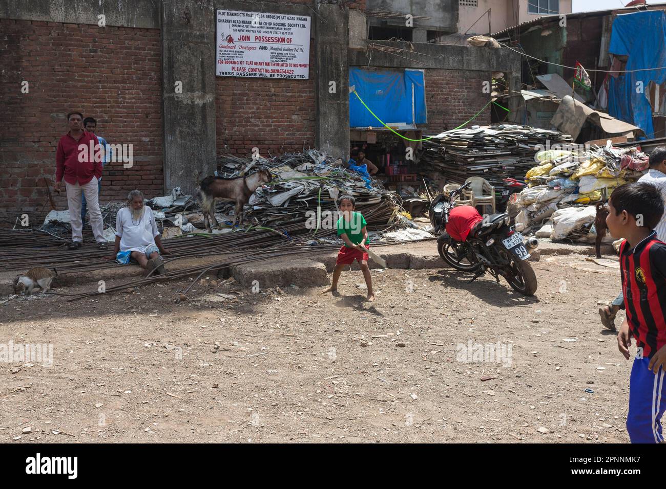 Cricket is a popular sport in India, across all social classes, children playing in a backyard, Dharavi, largest slum in Asia with up to 600, 000 Stock Photo