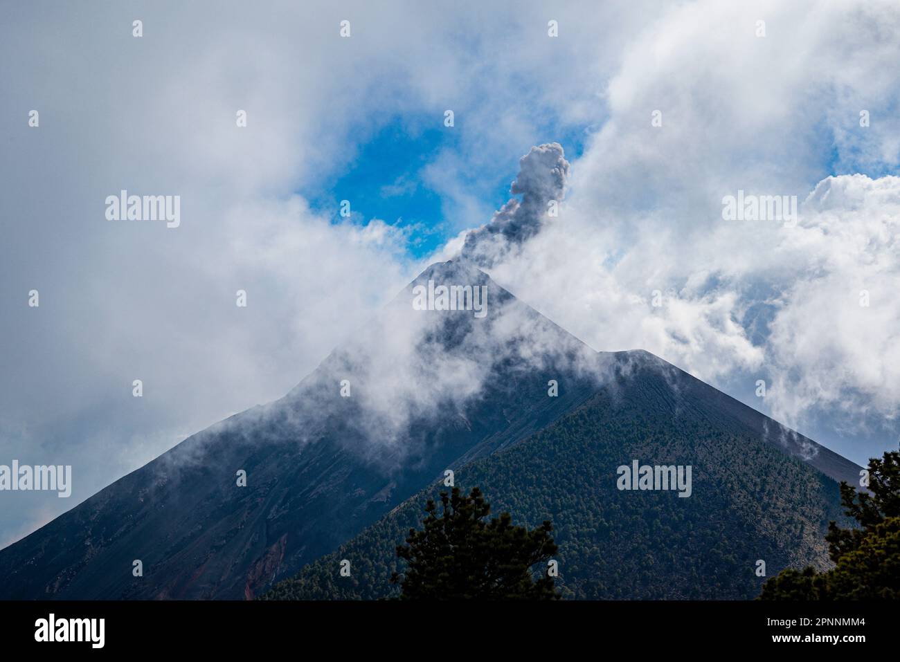 The dramatic view of El Fuego volcano in Antigua, Guatemala covered in ...