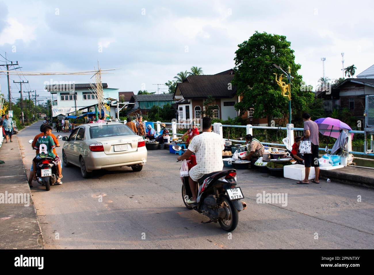 Thai people traveler travel visit and select buy shopping products goods food at local street market bazaar beside road morning time at Saen Suk Lampa Stock Photo
