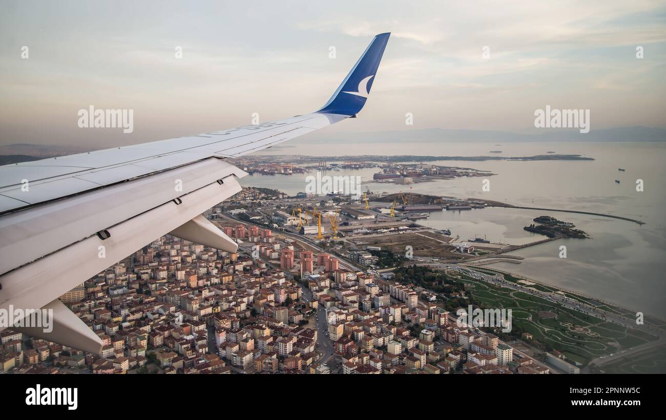 Anadolu Jet plane landing in Istanbul, the largest city of Turkey. As it descends towards the airport, it passess over the city's residential district Stock Photo
