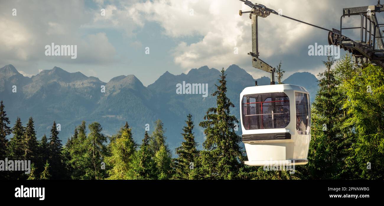 gondola ski lift in mountain ski resort, green forest Stock Photo