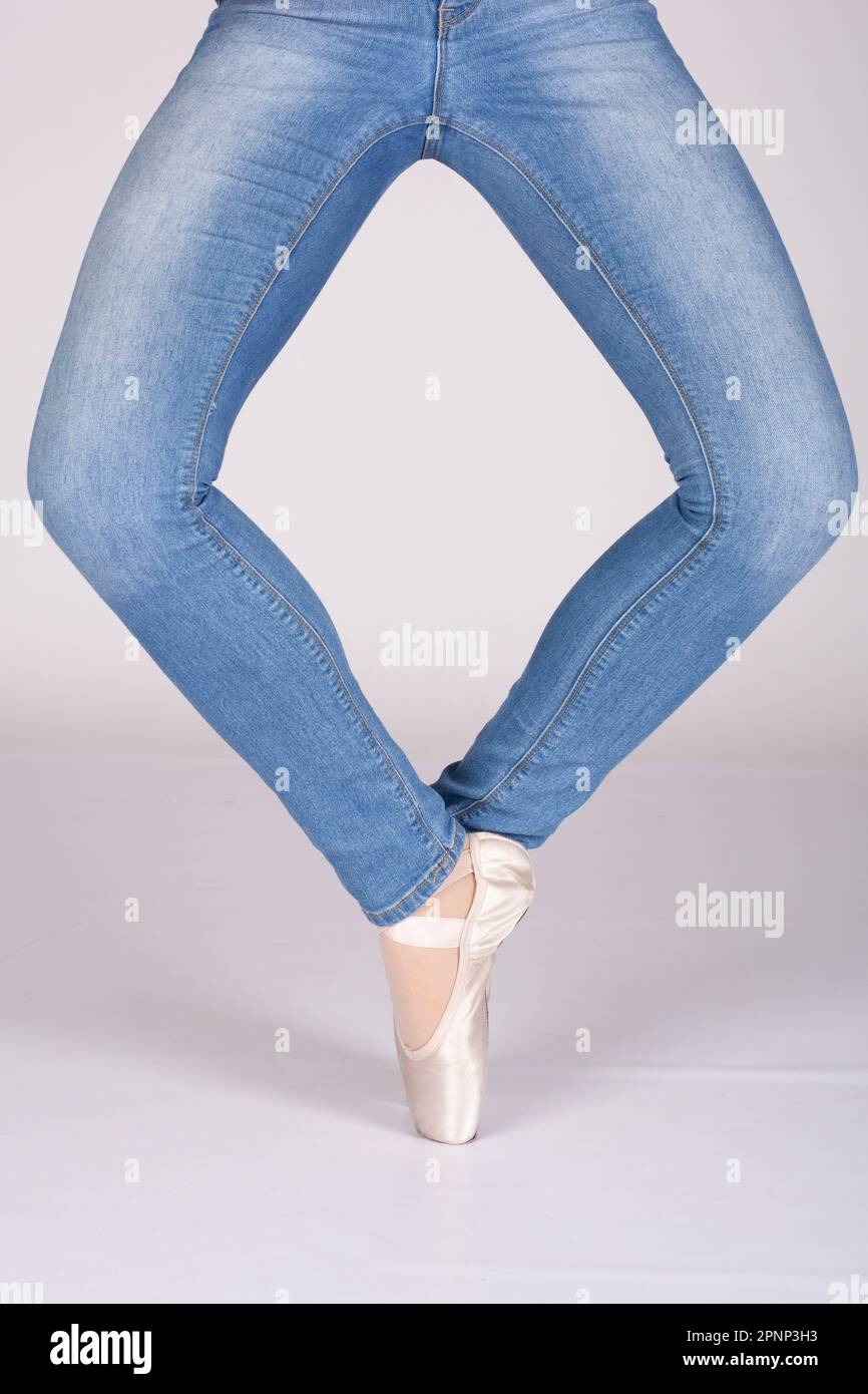 En pointe plie, legs in diamond shape. Girl wearing jeans and pointe shoes. Tight crop, no copy space Concept for diamond window Stock Photo