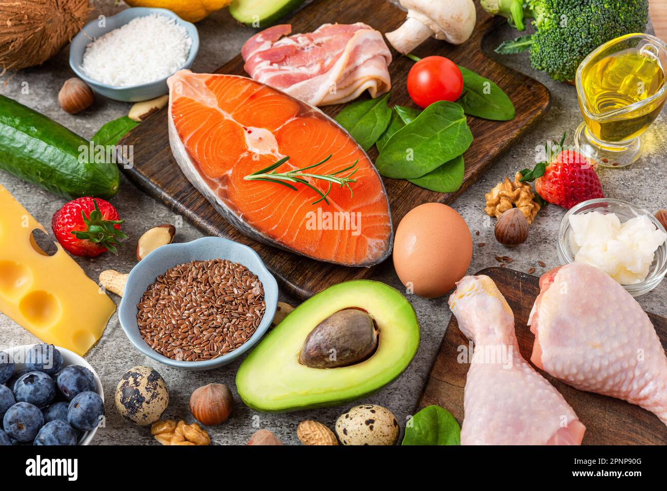 Healthy balanced diet food. Keto, low carb, atkins diet concept. Fish, meat, fruits vegetables, berries, mushroom and nuts Stock Photo