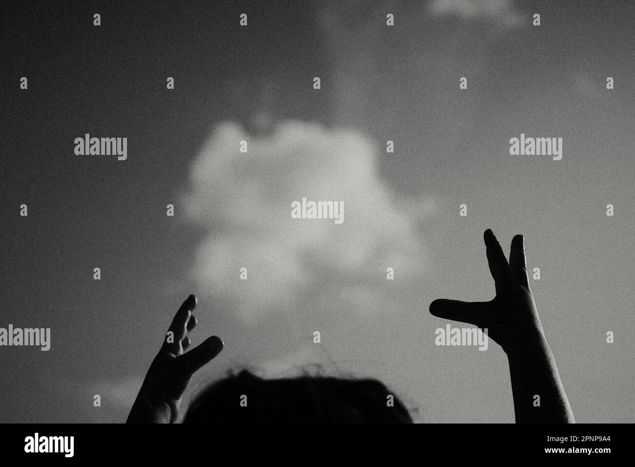 Child's hands holding cloud Stock Photo