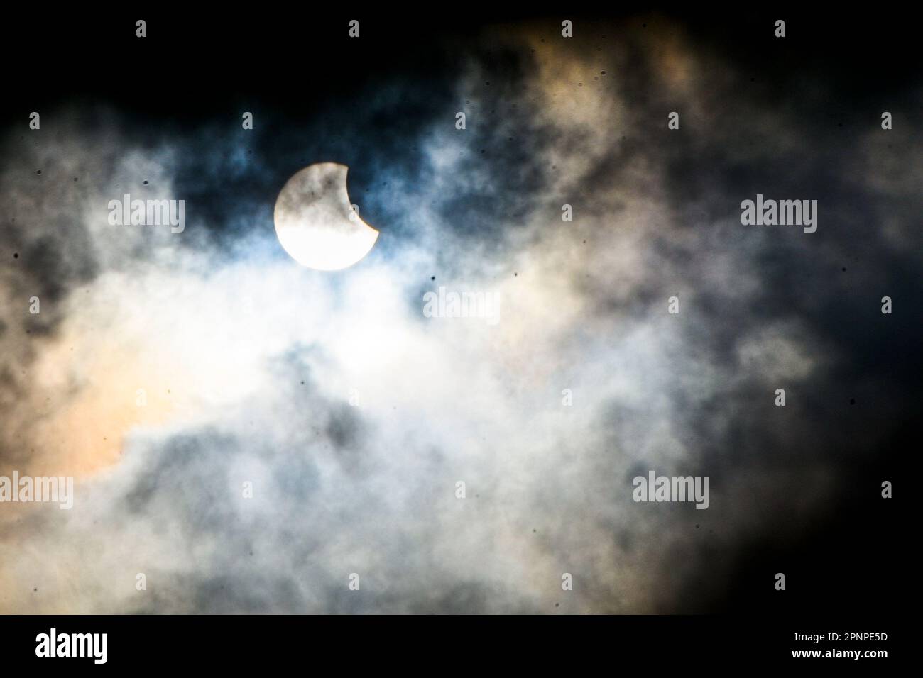 A general view shows a hybrid partial solar eclipse in Jakarta
