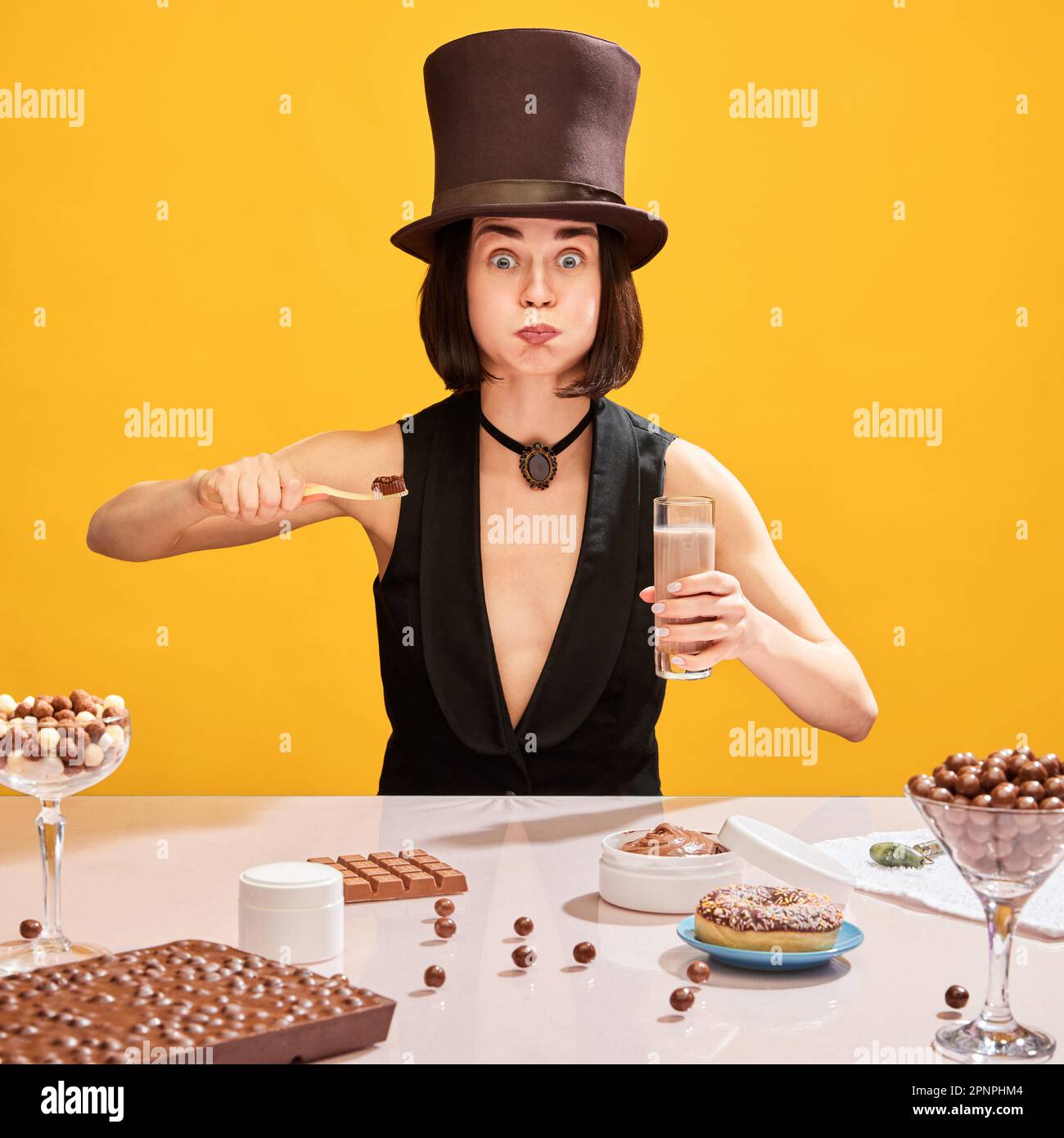 Woman in cylinder hat, brushing teeth with chocolate paste and rinsing