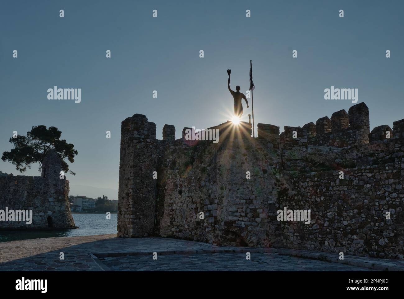 View of the Statue of Anemogiannis in the Medieval town of Nafpaktos at sunrise in spring Stock Photo