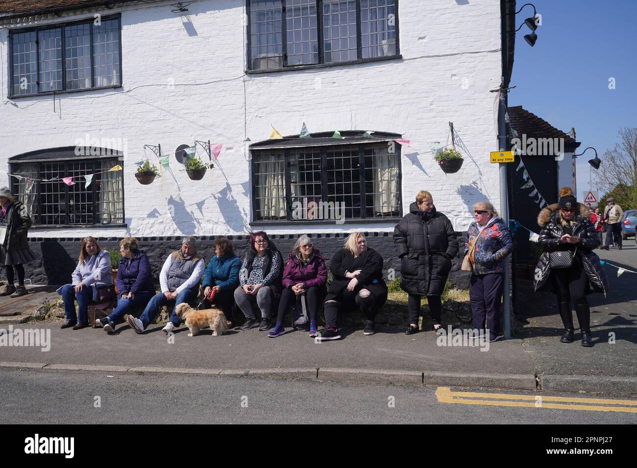 Well wishers wait outside the Walnut Tree Pub in Aldington, Kent, for