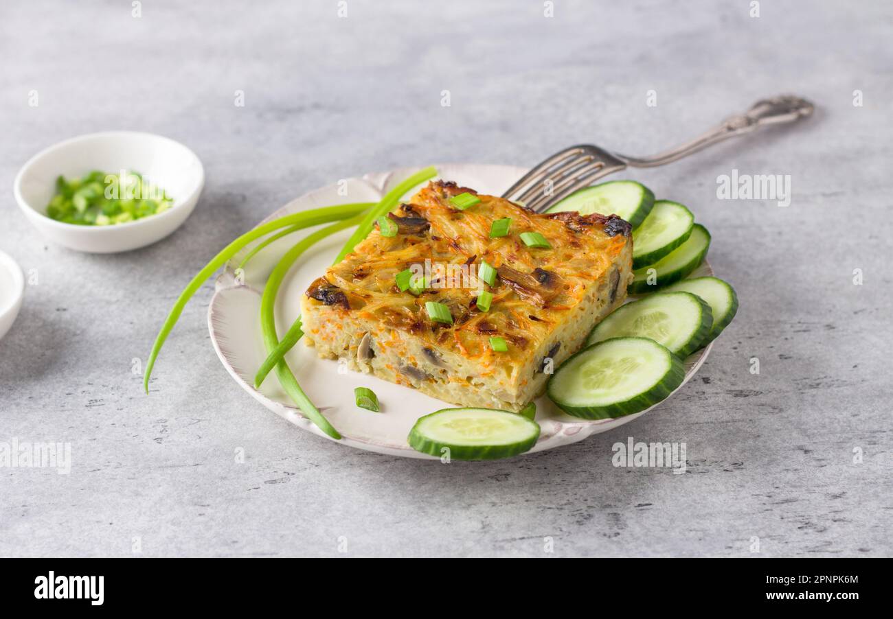 Vegetable casserole, kugel, from potatoes, carrots and mushrooms with
