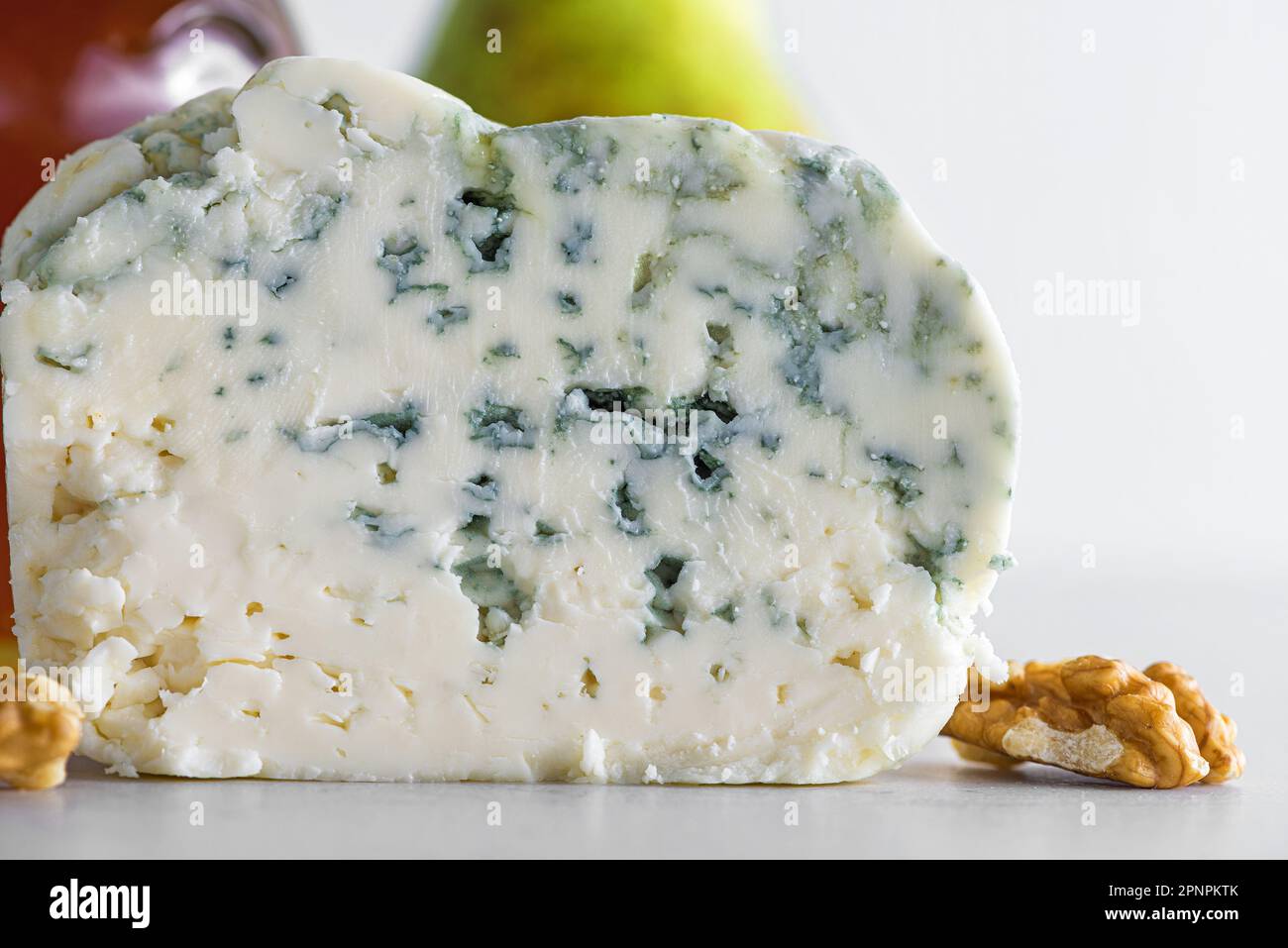 Delicious blue cheese dorblu or gorgonzola with pear and walnuts on white background. Close up. Tasty food Stock Photo