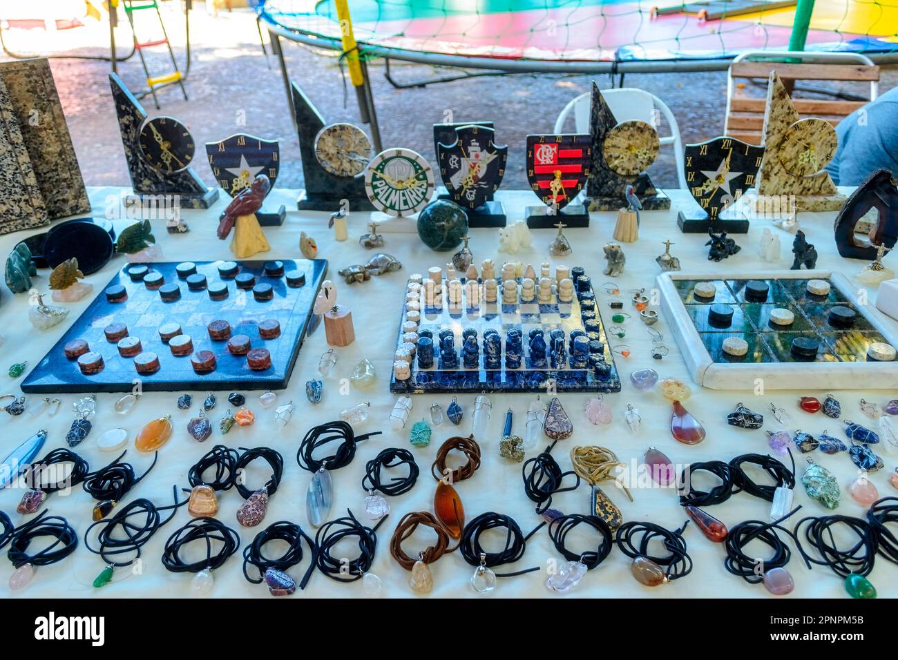 Rio de Janeiro, Brazil - April 4, 2023: Brazilian souvenirs exhibited on a table set in the boulevard or promenade in the Copacabana beach. Stock Photo