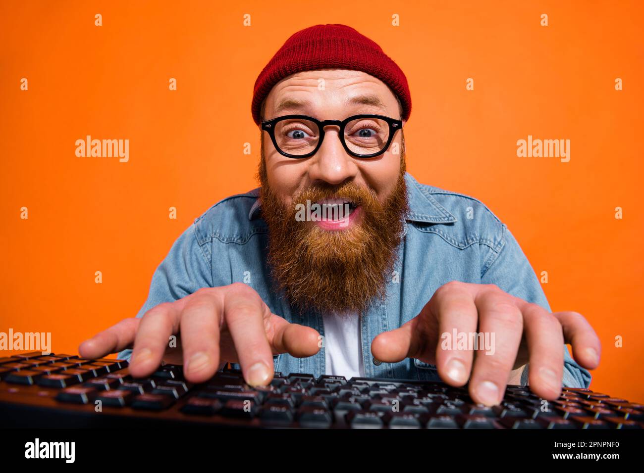 Portrait of excited young guy working on computer typing writing emails