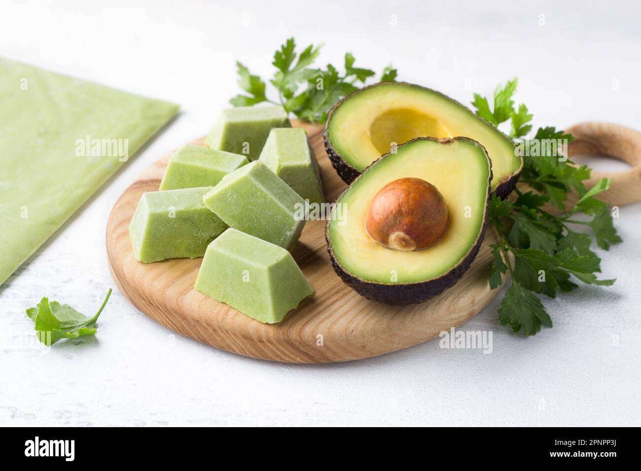 Frozen mashed avocado in portions and a thin layer with fresh avocado