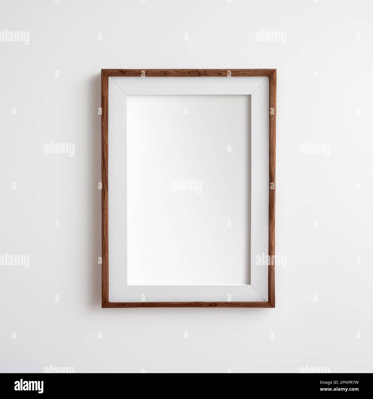 Wooden picture frame with vertical shape on a white wall mockup for pictures and posters Stock Photo