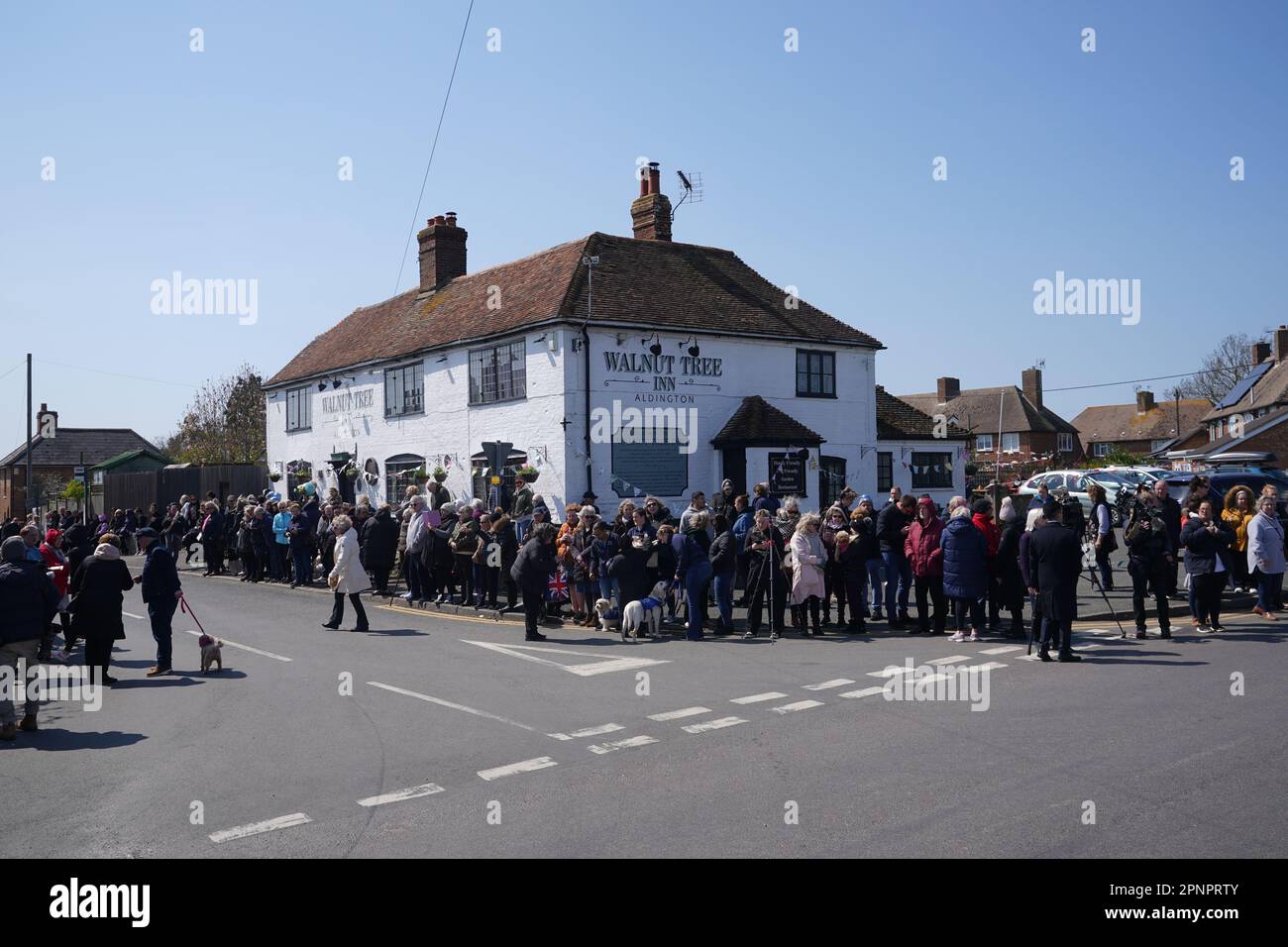 Wellwishers at the Walnut Tree Pub in Aldington, Kent, as they wait for Paul O'Grady's funeral cortege to travel through the village of Aldington, Kent, ahead of his funeral at St Rumwold's Church. Picture date: Thursday April 20, 2023. Stock Photo