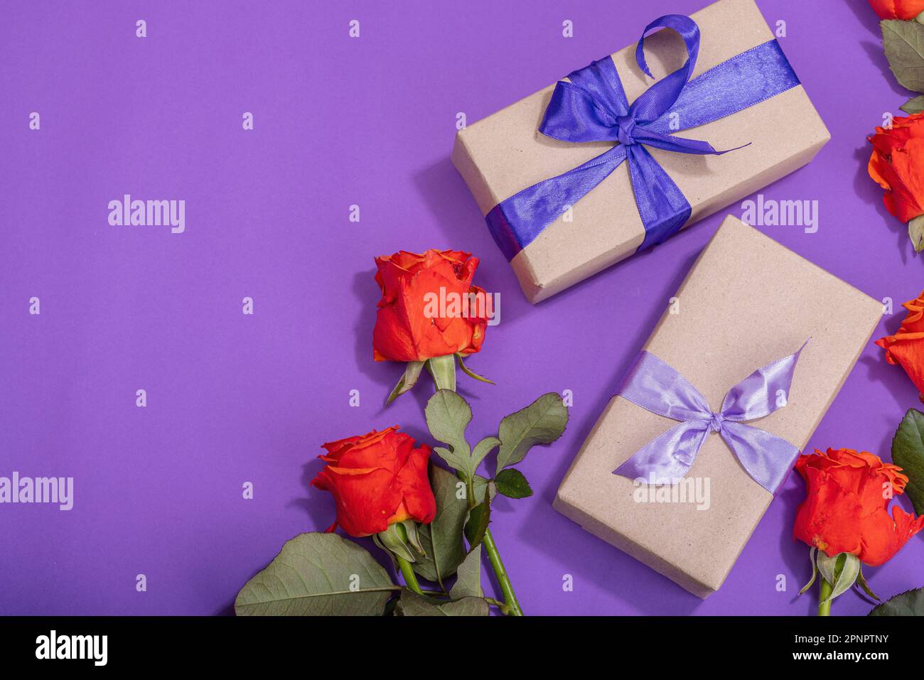 Zero waste gift concept. Bright roses, wrapped in craft paper surprise ...