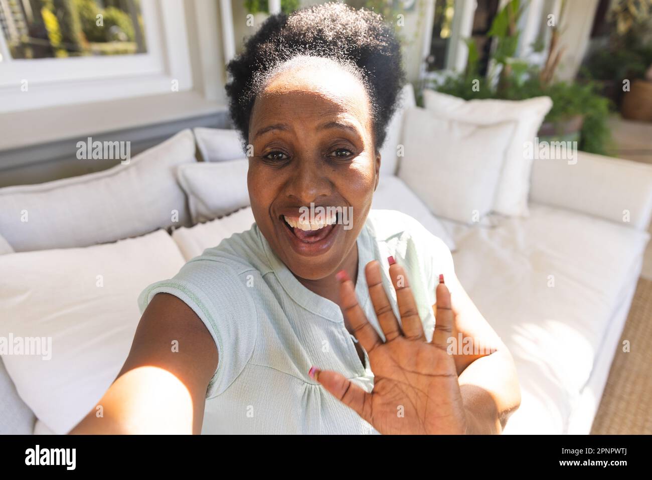 Happy african woman waving hand hi-res stock photography and images - Alamy