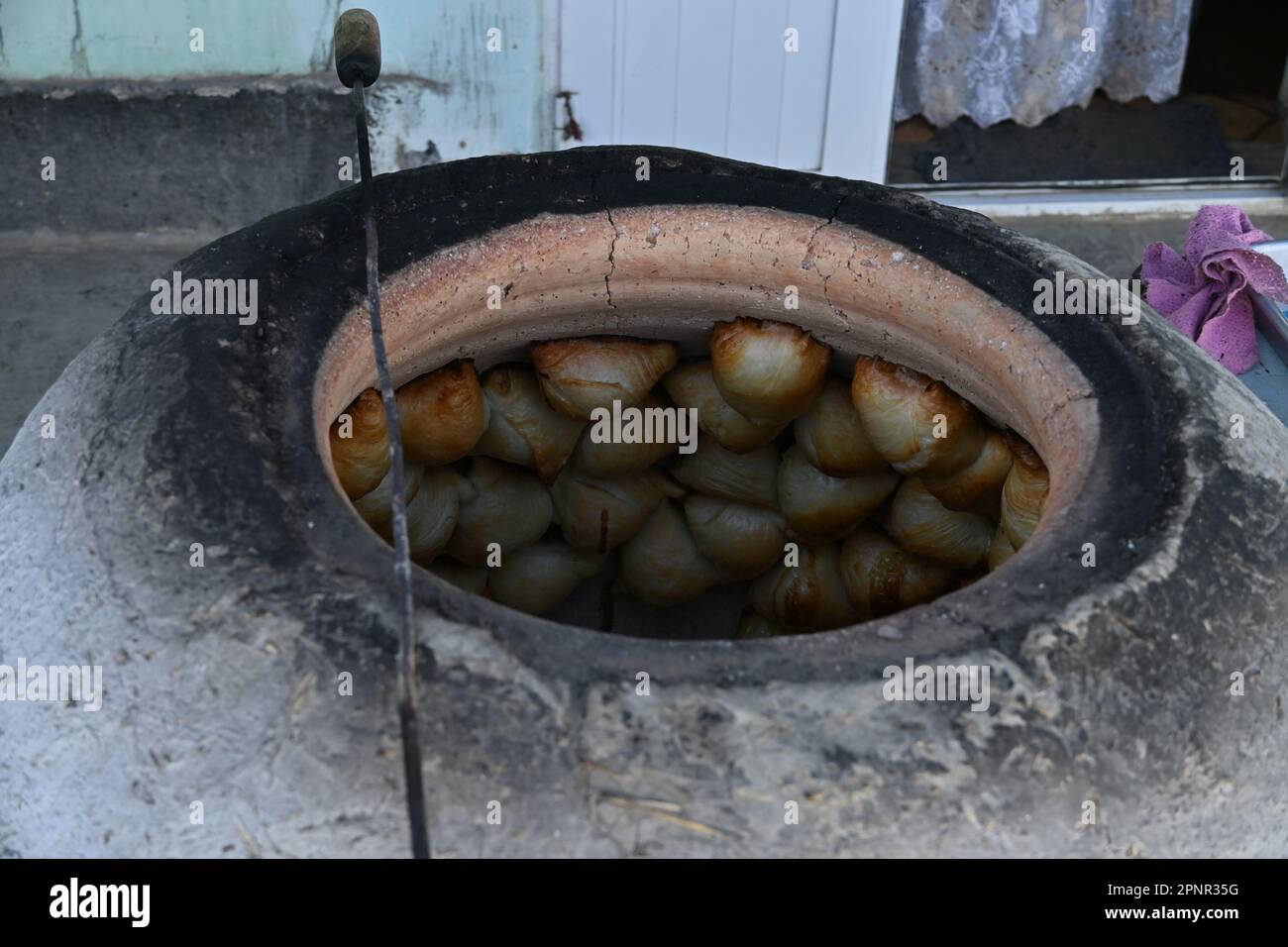 Close up of tandir oven with samsa inside, a traditional uzbek street food in Bukhara, Uzbekistan Stock Photo