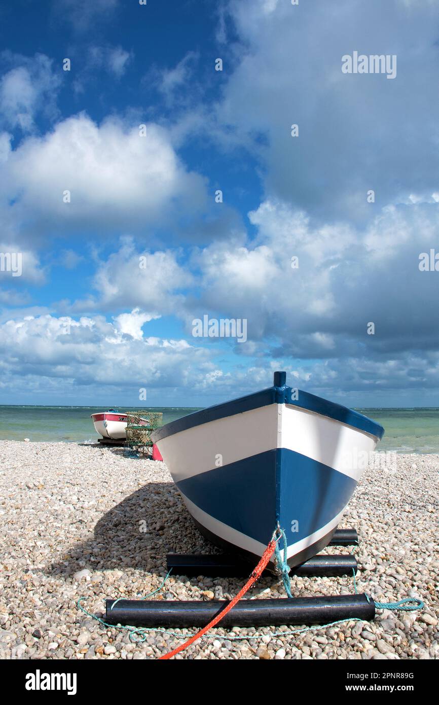 Fishing boat with fish trap against dramatic cloudy sky in Yport Stock Photo