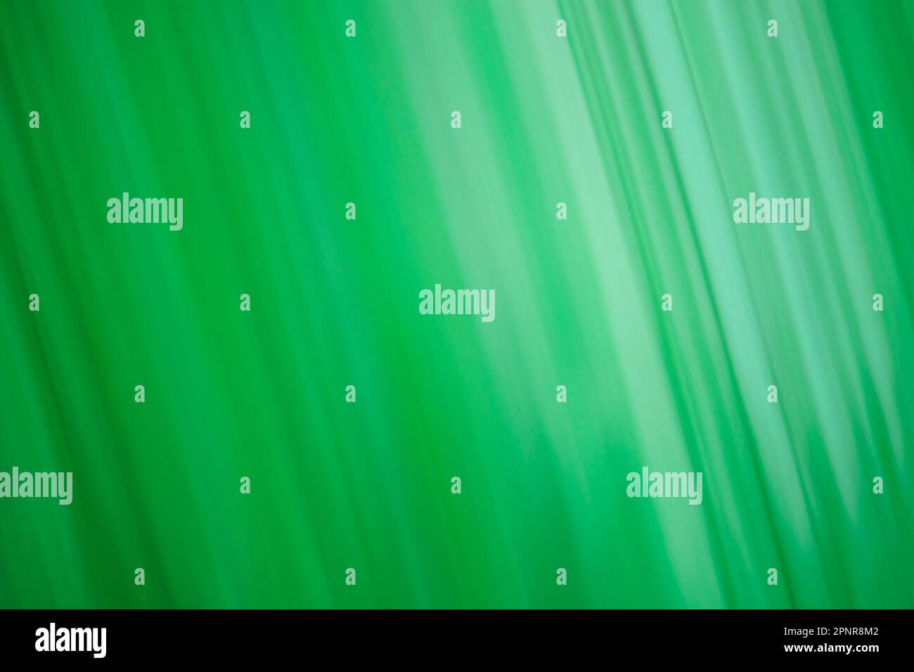 Pistachio color blur bokeh. Abstract green blurred gradient background with light. Stock Photo
