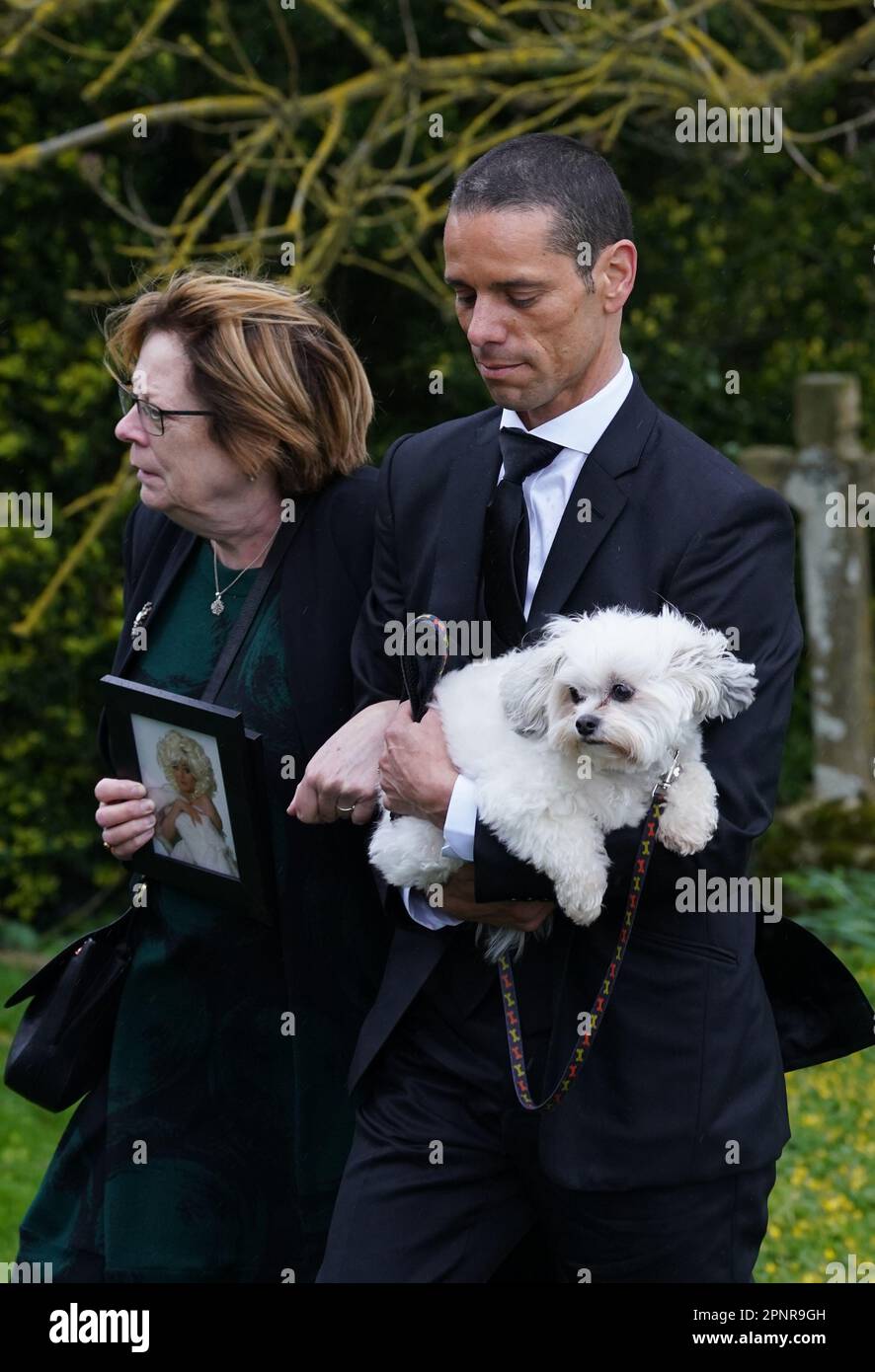 Husband of Paul O'Grady, Andre Portasio, carrying one of their dogs