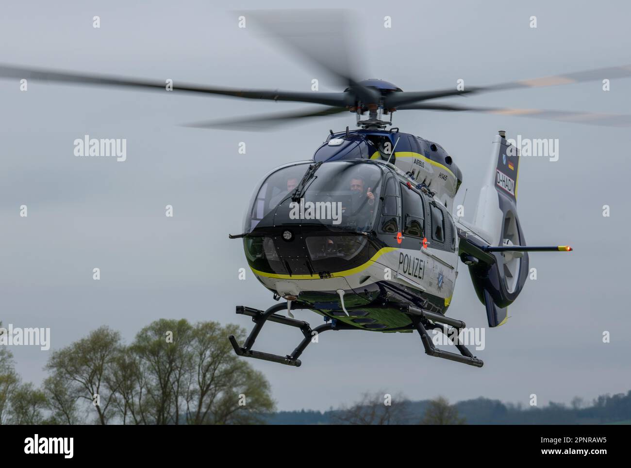 SCREENSHOT - 20 April 2023, Bavaria, Donauwörth: An Airbus H145 helicopter in the colors of the Bavarian police flies at the Aibus Helicopters factory airfield. The Free State of Bavaria received the first two of a total of eight new aircraft ordered from Airbus Helicopters for a total of 145 million euros. Photo: Stefan Puchner/dpa Stock Photo