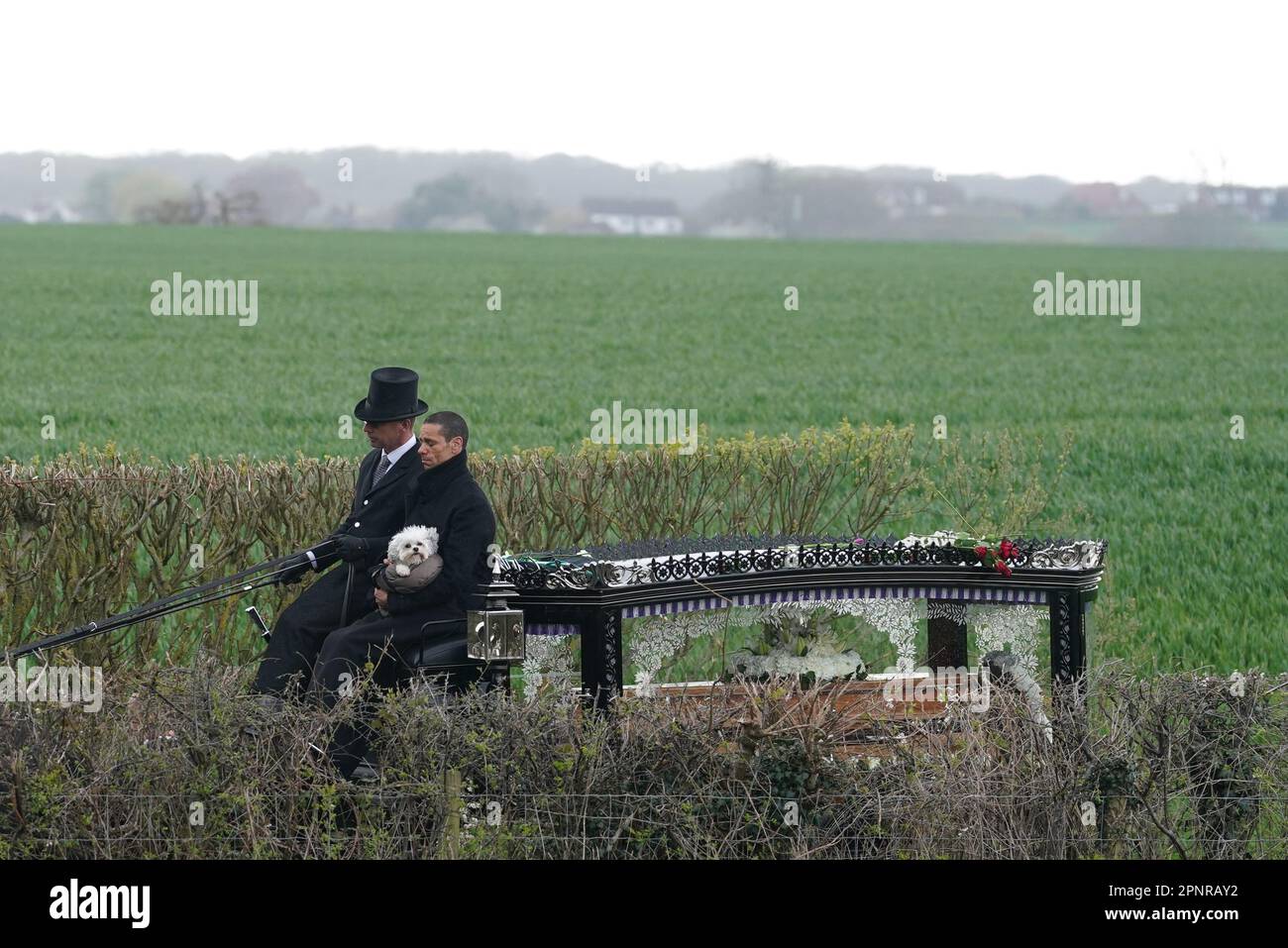 Husband of Paul O'Grady, Andre Portasio, carrying one of their dogs