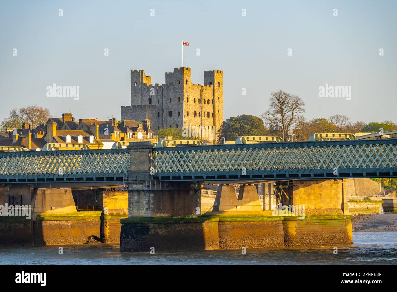 The keep of Rochester Castle with the Medway rail bridge in foreground. Stock Photo
