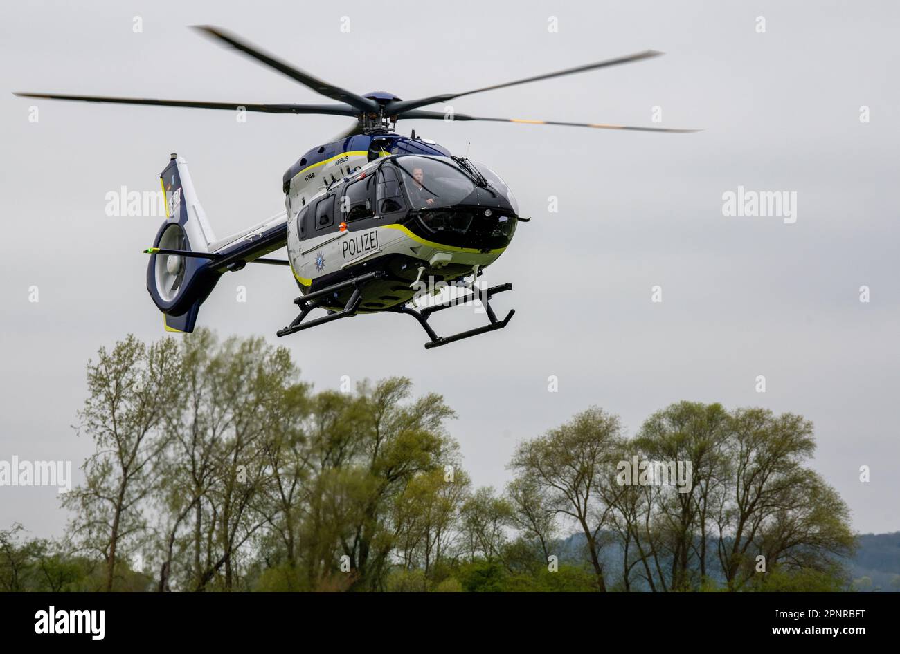 SCREENSHOT - 20 April 2023, Bavaria, Donauwörth: An Airbus H145 helicopter in the colors of the Bavarian police flies at the Aibus Helicopters factory airfield. The Free State of Bavaria received the first two of a total of eight new aircraft ordered from Airbus Helicopters for a total of 145 million euros. Photo: Stefan Puchner/dpa Stock Photo