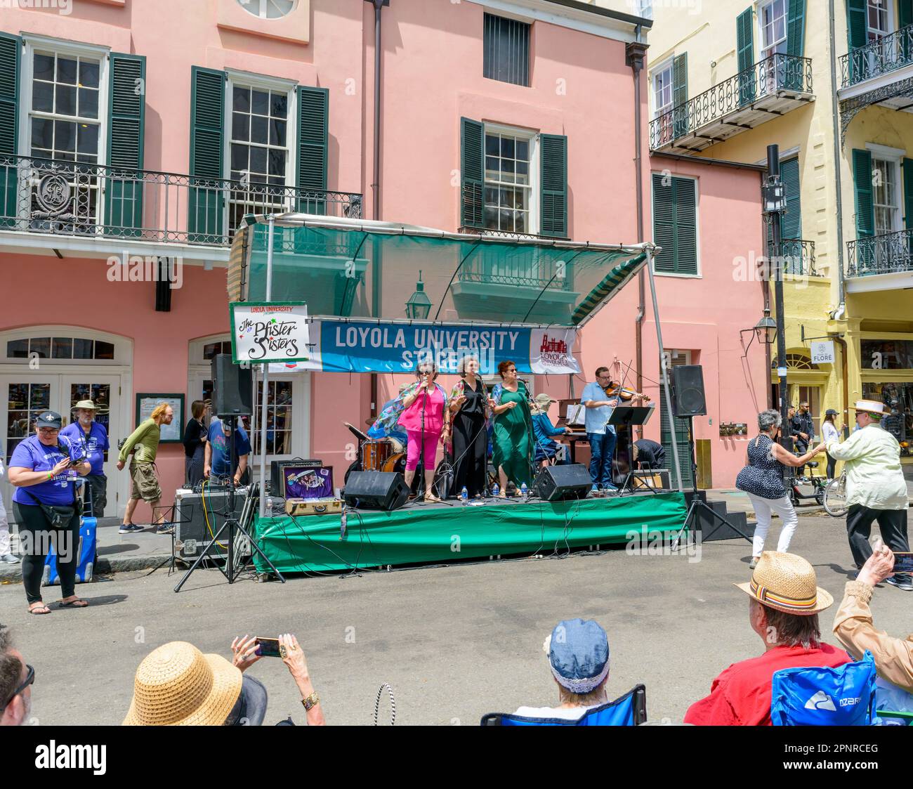 NEW ORLEANS, LA, USA - APRIL 16, 2023: The Pfister Sisters perform with dancing couple and crowd at the French Quarter Festival Stock Photo